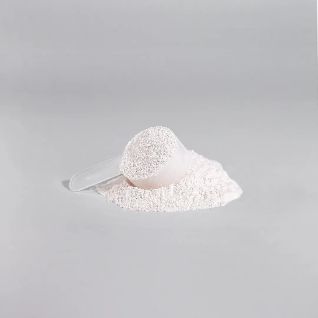 White powder in a scoop on a gray background